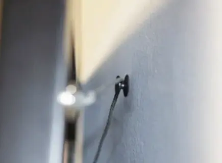 DécoNails in use — wall-friendly picture hanging nail industrial design